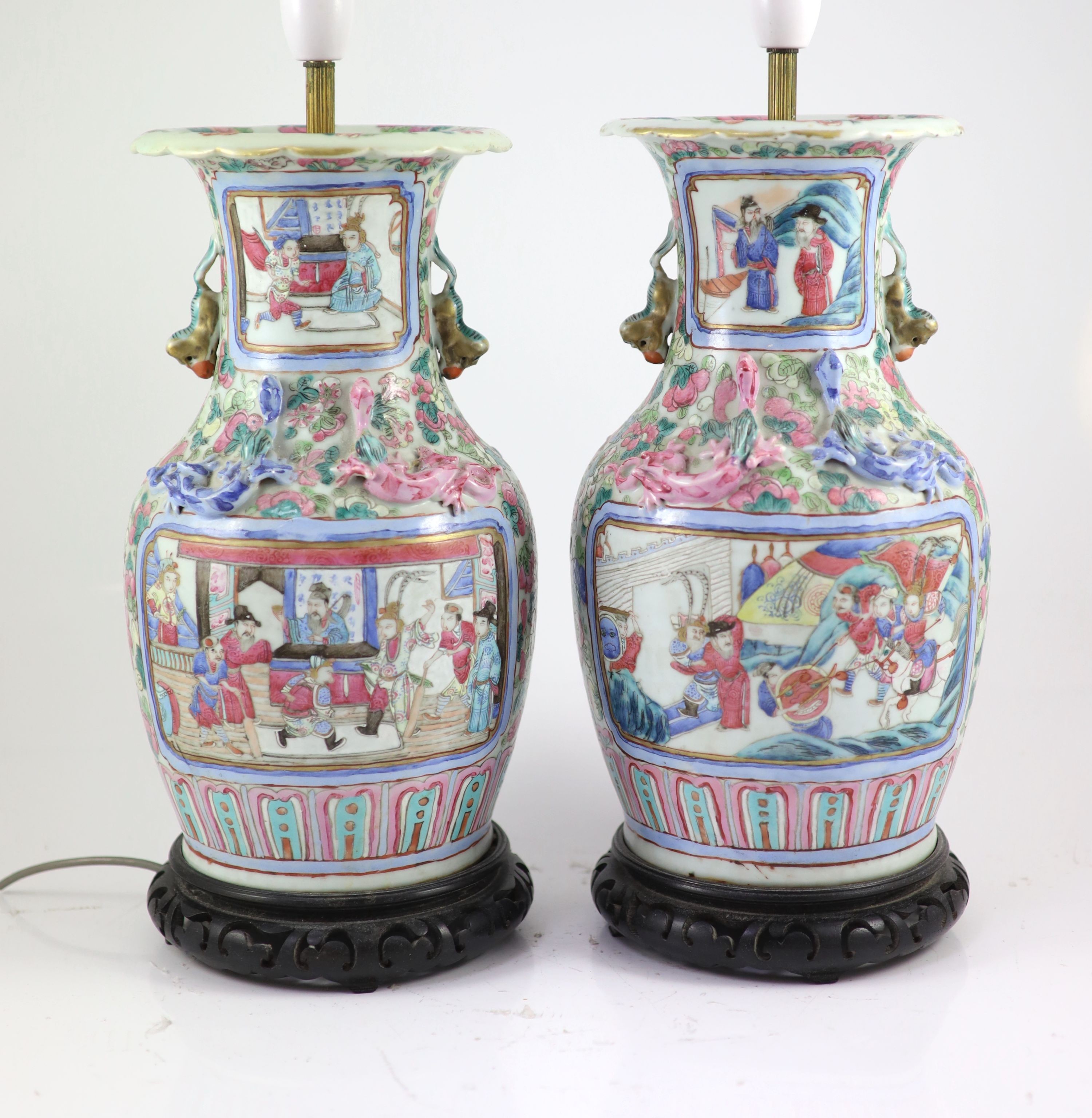 A pair of 19th century Chinese famille rose baluster vases, fitted as table lamps, on hardwood stands